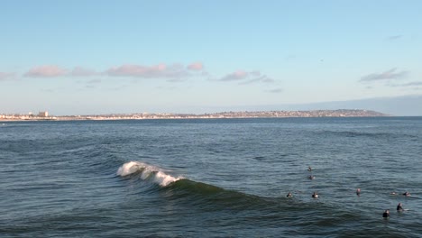 Surfers-In-The-Ocean-At-Bird-Rock-In-La-Jolla-During-Daytime-In-San-Diego,-California