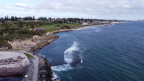Aerial-view-to-South-Cottesloe-Beach,-descending-over-groin,-Perth,-Western-Australia