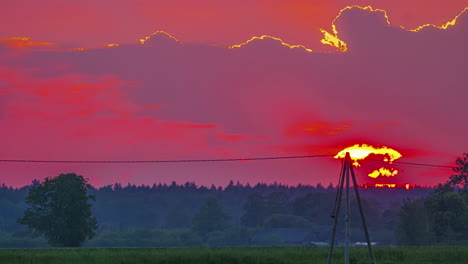 Red,-fiery,-zoomed-in-time-lapse-above-a-forested-landscape