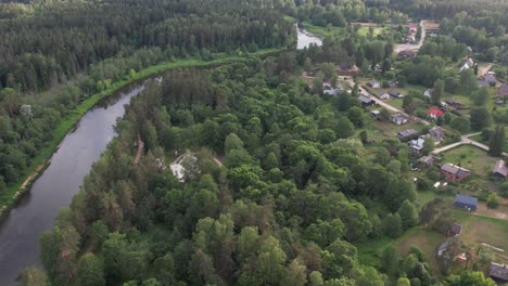 An-aerial-view-of-Valmiera-city,-showcasing-its-blend-of-urban-and-natural-elements