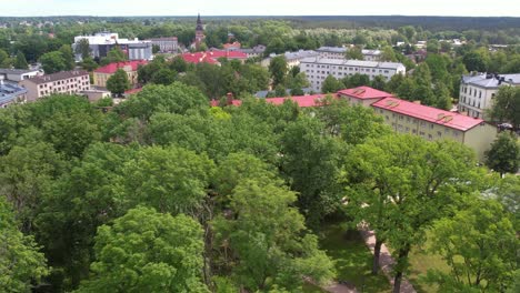 An-aerial-view-of-Valmiera-city,-showcasing-its-blend-of-urban-and-natural-elements