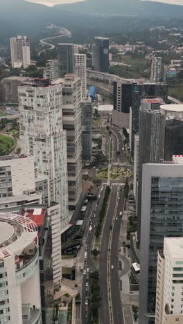 Aerial-view-between-buildings-in-the-Santa-Fe-district-of-Mexico-City,-vertical-mode