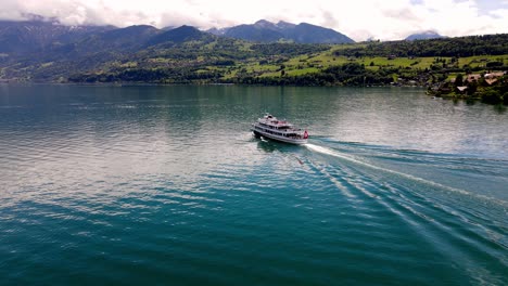 Aerial-take-of-the-Thunensee-lake-in-Swiss-alps,-nearby-Interlaken-town