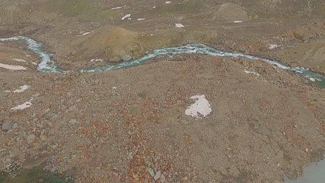 4K-fly-forward-drone-shot-revealing-the-course-of-a-stream-originating-from-a-Himalayan-glacial-lake