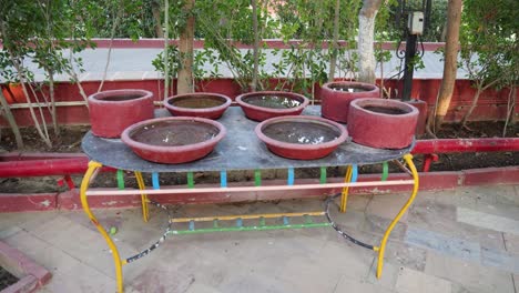 Instalación-Para-Beber-Agua-De-Aves-Con-Vasija-De-Barro-Llena-De-Agua-Al-Aire-Libre-Por-La-Noche