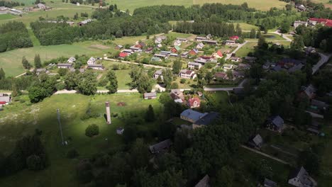 Aerial-view-of-Diklu-Stage-in-Dikli-village,-showcasing-the-open-air-performance-venue-surrounded-by-lush-greenery-and-nearby-buildings