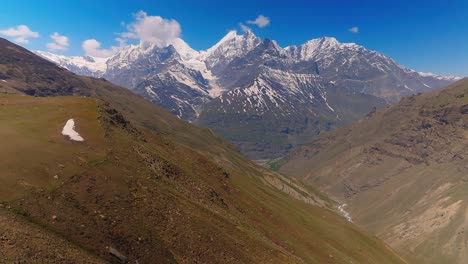 4K-Drone-Revealing-shot-of-snow-capped-Himalayan-Pir-Panjal-range-on-a-bright-sunny-day