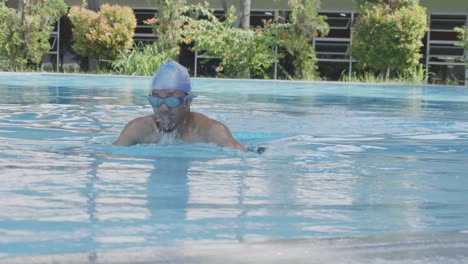 Young-Man-Wear-Glasses-Training-Swimming-Breaststroke-Style-In-A-Swimming-Pool