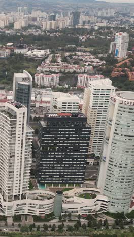 Luxury-buildings-in-Santa-Fe,-Mexico-City,-vertical-drone-captures