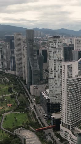 Elevated-perspective-of-office-and-residential-skyscrapers-in-Santa-Fe-financial,-CDMX,-vertical-format