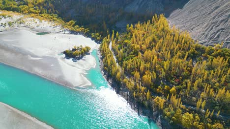 Aerial-top-view-of-turquoise-water-lake-flowing-through-Skardu-Valley-during-month-of-spring-in-Skardu,-pakistan