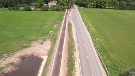 An-aerial-view-of-Livi-city,-highlighting-its-green-spaces-and-extensive-cycle-paths-next-to-the-main-road