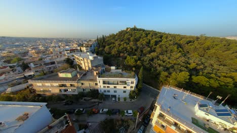 Fliegen-Einer-FPV-Drohne-Auf-Einem-Hügel-In-Athen,-Griechenland,-In-Der-Nähe-Der-Akropolis-Und-Des-Parthenon-Bei-Sonnenuntergang