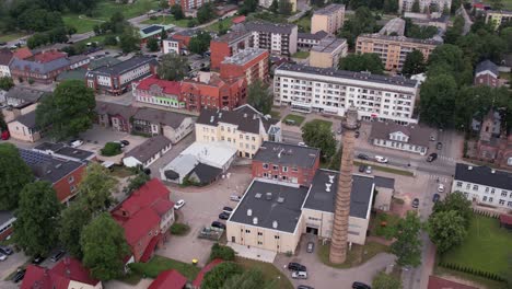 An-aerial-view-of-Valmiera-city,-showcasing-its-blend-of-urban-and-natural-elements