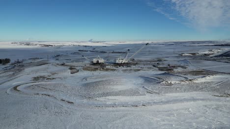 4K-Drone-video-of-snowy-plains-in-North-Dakota-with-a-large-white-mining-Crain-in-the-background