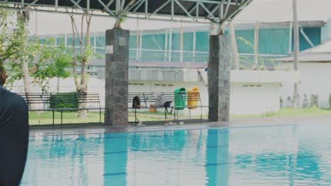 Young-Asian-woman-Using-Towel-To-Wipe-Her-Face-After-Swimming-Exercise