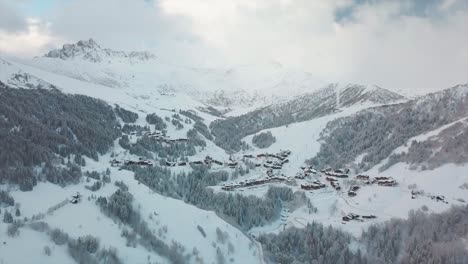 Vista-{aérea}-De-Un-Dron-Sobre-Una-Estación-De-Esquí-Nevada-Francesa-Durante-El-Invierno