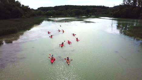 Landscape-aerial-view-of-people-kayaking-in-pairs-on-Danube-river,-Hungary