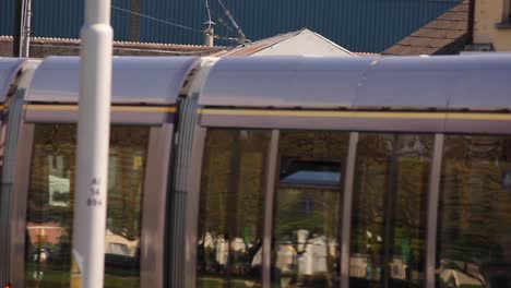 Dublin-public-transportation-luas-tram-with-direction-to-Tallaght-passes-by-the-canal-in-the-city