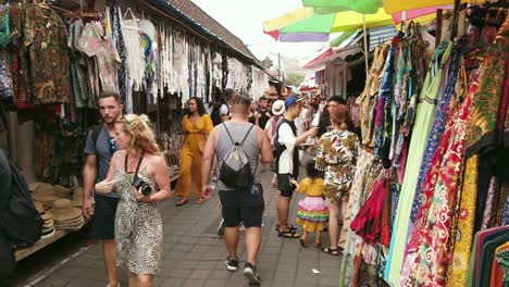 Tourists-and-local-people-sightseeing-and-shopping-in-a-colorful-open-market-selling-clothing-and-souvenirs