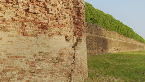 Pan-right-medium-shot-of-Ferrara's-historic-city-walls-with-clear-sky-during-a-beautiful-sunny-day