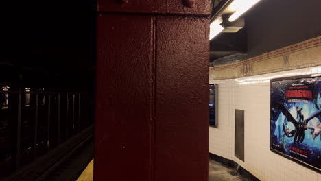 Print-billboards-and-digital-monitor-advertising-sit-next-to-one-another-on-23-street-subway-platform