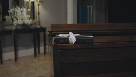 Book-Wrapped-with-a-Bow-Laying-on-Top-of-a-Piano-in-a-Hotel-Room