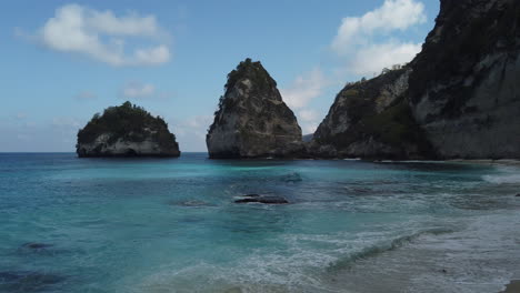 Panning-left-to-right-to-reveal-a-beautiful-Blue-Lagoon-Beach-as-unidentified-people-lay-out