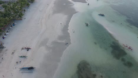 Drone-shot-of-the-beautiful-Paradise-Beach-coastline-in-Bantayan-Philippines-with-baroto-boats-on-the-shore