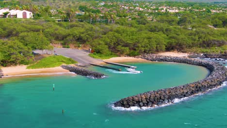 Boat-ready-to-go-fishing,-Flying-low-along-the-coast-of-Kihei,-Hawaii-on-a-sunny-day