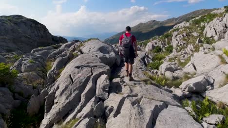 A-follow-cam-of-a-hiker-walking-on-rocks