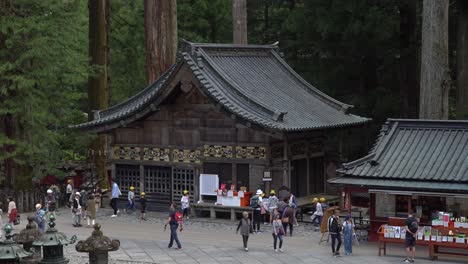 Touristists-taking-photos-from-the-very-famous-restored-carving-of-the-three-monkeys-at-the-stables,-located-in-the-site-of-Toshogu-Shrine-temple