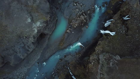 Aqua-Blue-River-and-Waterfalls-in-Highlands-of-Iceland,-High-Angle-Drone-Aerial-View