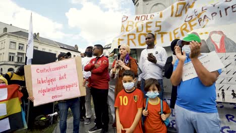 Female-speaker-addressing-protest-crowd-in-Brussels-during-pandemic