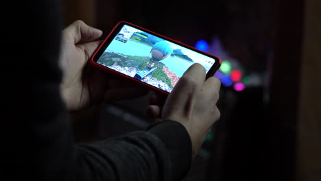 Man-playing-Fortnite-using-a-smartphone