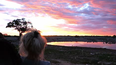 Little-child-looking-at-Okaukuejo-waterhole-at-sunset-in-Etosha-National-Park