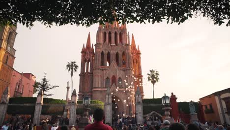 Balloons-released-in-front-of-Mexican-cathedral-church-with-onlooking-tourists-during-celebration-at-sunset-slow-motion
