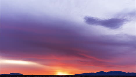 The-fiery-red-skies-of-sunset-with-indigo-clouds-rolling-overhead---Time-lapse