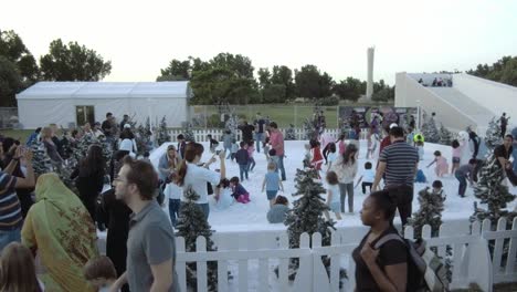 The-Beautiful-Winter-Carnival-In-Abu-Dhabi,-UAE-With-People-Having-Fun-In-The-Snow-Filled-Area-And-Snow-Slide---Wide-Shot