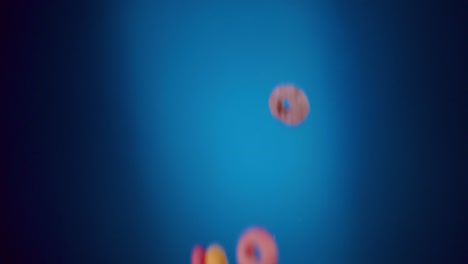Breakfast-Cereals-Fruity-Loops-Falling-in-Slo--Motion-with-blue-background