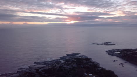 Aerial,-tracking,-drone-shot-overlooking-the-Skagerrak-ocean-and-the-rocky-coast-of-the-Justoya-island,-partly,-sunny-morning,-in-Aust-Agder,-Norway