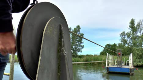 Cable-ferry-is-brought-in-by-turning-a-wheel