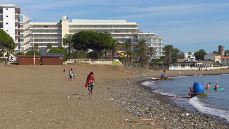 4k-Marbella-beach-panning-left-with-gimbal,-summer-day-at-the-beach-on-the-Costa-del-sol,-south-of-Spain