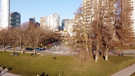 Aerial-Pan-Out-from-a-residential-area-to-Sunset-beach,-while-a-Courier-Truck-drives-down-a-street-and-turns-on-a-side-street