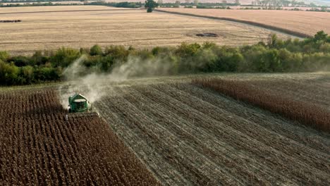 Aerial-view-John-Deere-machine-in-Bulgarian-sunflower-field-harvesting-seeds-early-summers-evening
