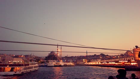 Slow-motion:Unidentfied-people-have-Istanbul-boat-tour-with-view-of-bosphorus-and-New-Mosque-at-sunset-in-istanbul,Turkey