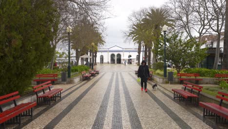 People-passing-on-a-street-in-Tavira,-Algarve-with-a-Coreto,-in-Portugal