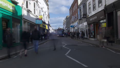 Hustle-and-bustle-of-people-shopping-in-sales-in-busy-city-high-street-with-traffic,-time-lapse