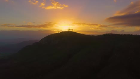 Drone-footage-of-Sunrise-over-Mount-Stuart,-Townsville-Australia