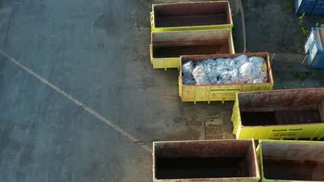 Drone-Aerial-View-of-Empty-Garbage-Containers-From-Renovasjonen-IKS-Company,-Stavanger,-Norway